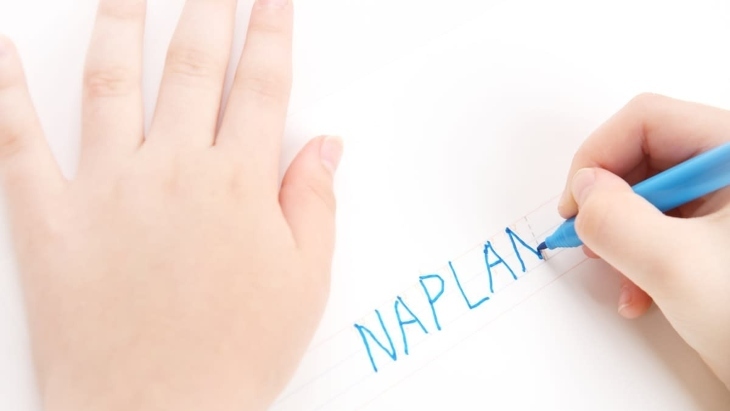 A child writing the word NAPLAN