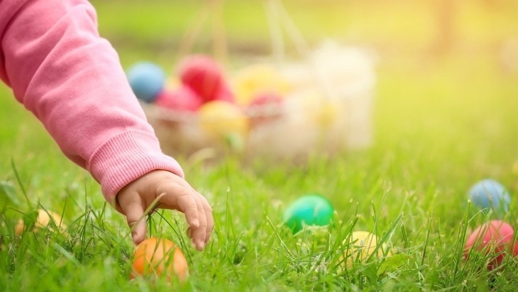 Girl looking for easter eggs in grass