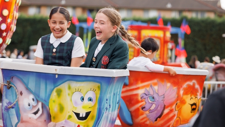 Girls laughing on a ride at PLC Sydney Open Day
