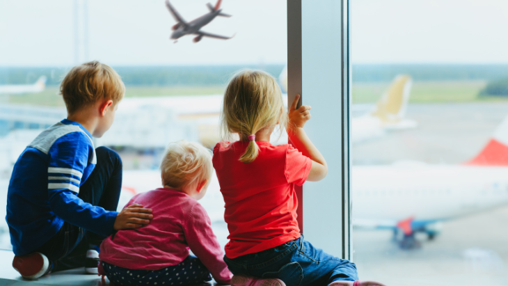 Family looking at airplanes at airport