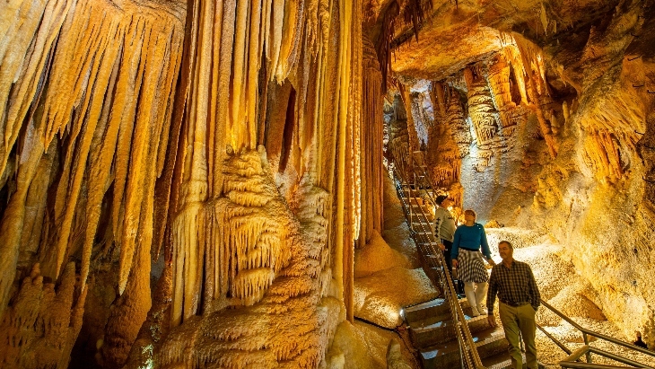 Visitors walking down stairs into Jenolan Caves