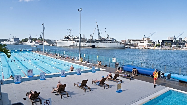 Andrew Boy Charlton Pool with navy ships in the background