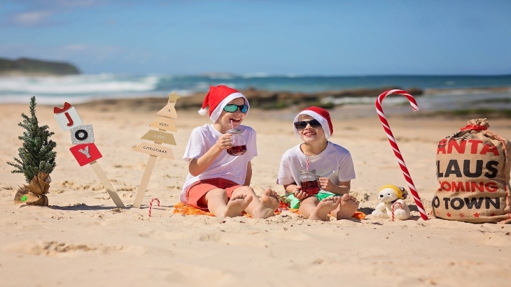 Boys sitting on the beach at Christmas