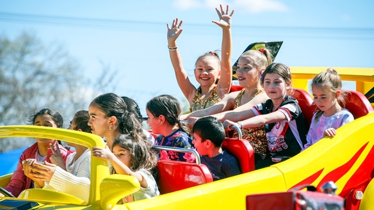 Kids riding a carnival ride at Kenthurst Fair