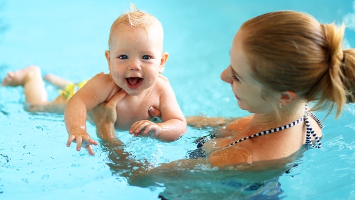 Mother and baby in a pool