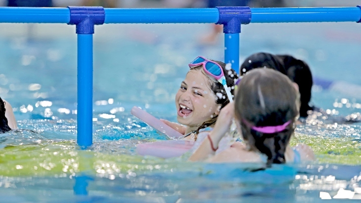 Girl jumping into City of Sydney Pools