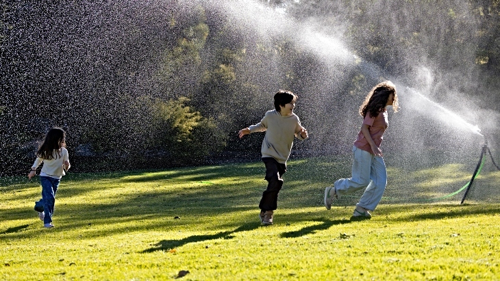 Kids playing in the sprinklers at Australian Botanic Garden Mount Annan