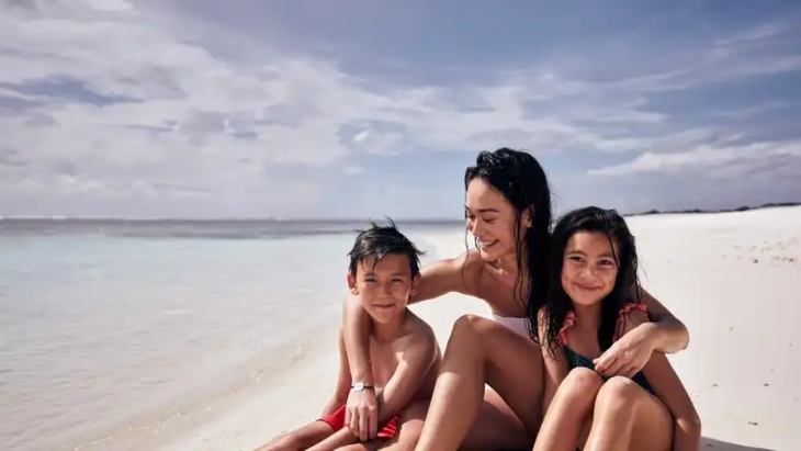 A family on the beach at Club Med Borneo