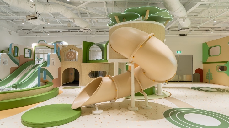 Beige and green slides in indoor playground