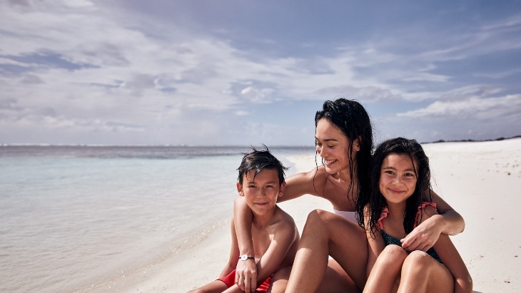 Mother and children on a beach
