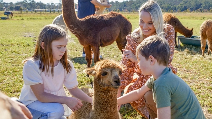 Mother and children petting alpacas at Iris Lodge Alpacas Sydney