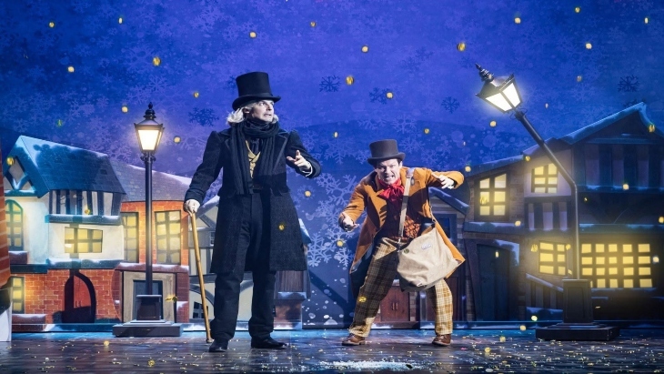 Two men in top hats on stage in nighttime street scene