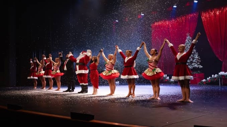 Christmas stage performers taking a bow in big line
