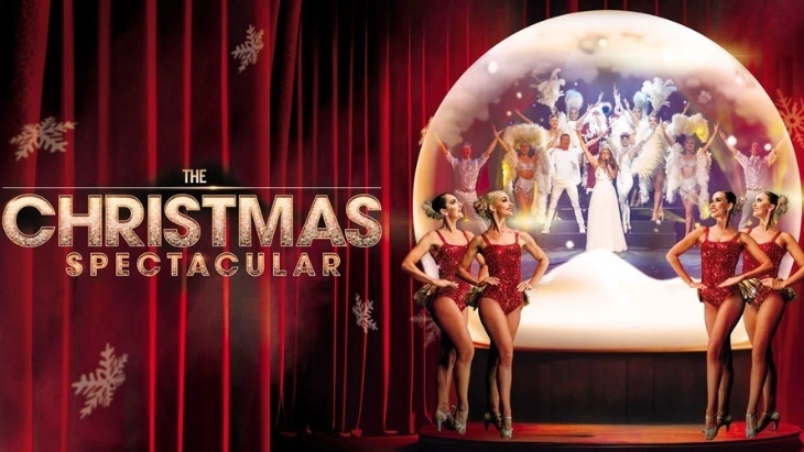 The Christmas Spectacular. Four dancers stand outside a snow gobe