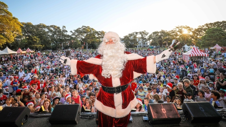 Santa on stage in front of hundreds of people 