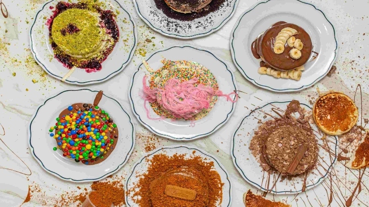Stacked colourful pankcakes on table 