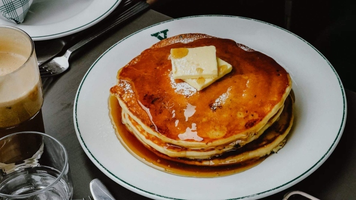 Atack of pancakes with butter and honey on top