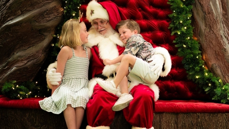 Santa hugging a boy and girl