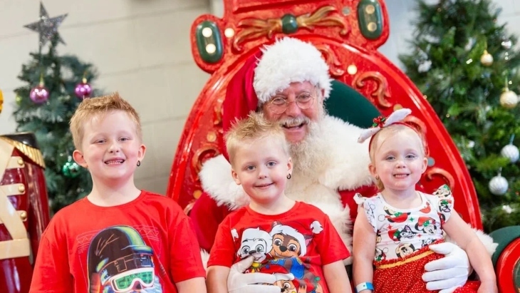 Santa smiling with boys and girls
