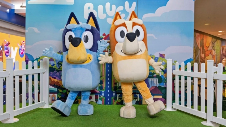 Bluey and Bingo on a stage