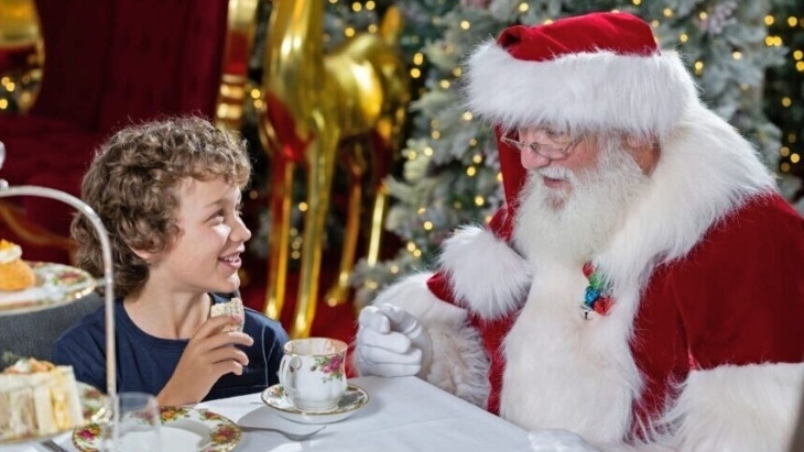 Santa having tea with a little boy on Christmas