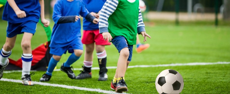 boys kicking football soccer game. training session, physical education class for kids