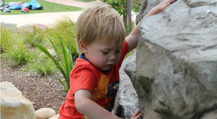 boy climbing rock