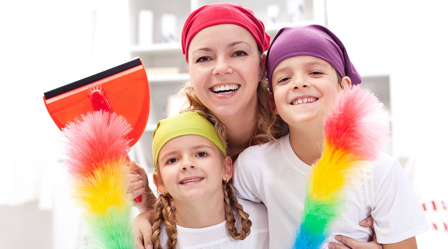 Cleaning task-force - woman with kids holding utensils